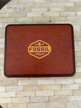Fossil wine accessory set featuring a corkscrew, stopper, and charms